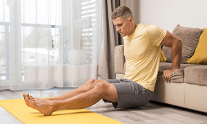 man-working-out-home-using-couch-(1)