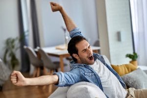 Young exhausted man yawning